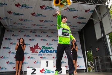Sprint winner Tom-Jelte Slagter (right) of Cannondale-Garmin throws flowers to the crowd during the stage presentation at the end of Stage 5 of the Tour of Alberta, which ran from Edson to Spruce Grove, in Spruce Grove, Alta., on Sunday September 6, 2015. The race finishes in Edmonton on Sept. 7. Ian Kucerak/Edmonton Sun/Postmedia Network