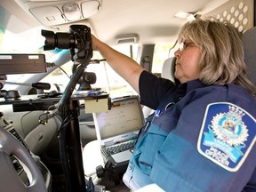 An Edmonton police officer uses photo radar in the file photo. (EDMONTON SUN/File)