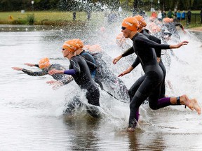 Participants in the Women’s Elite race run into the water to start the 2015 ITU World Triathlon Edmonton on an already rainy, wet day at Hawrelak Park on Sunday, Spetember 7, 2015. DAVID BLOOMéEdmonton Sun