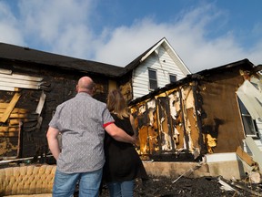 Brian and Kaleena Hanoski stand outside the remains of their home on Saturday September 5, 2015 on Tyendinaga Mohawk Territory, Ont. A fire tore through their newly renovated house last Wednesday, just 10 days before they were scheduled to move in. Tim Miller/Belleville Intelligencer/Postmedia Network