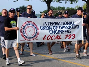 Members of the International Union of Operating Engineers Local 793 march down Front Street in Sarnia during the Labour Day Parade. The parade marshal said there were around 49 entries.  Terry Bridge/Sarnia Observer/Postmedia Network