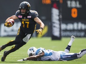 Tiger-Cats' Luke Tasker evades a tackle by Argonauts' Branden Smith during first half CFL action in Hamilton on Monday, Sept. 7, 2015.    (Mark Blinch/Reuters)