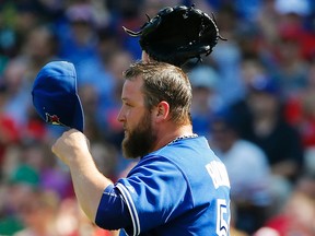Blue Jays pitcher Mark Buehrle heads back to the mound after giving up a hit to the Red Sox during third inning MLB action at Fenway Park in Boston on Monday, Sept. 7, 2015. (Winslow Townson/AP Photo)