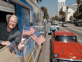 Actor Martin Milner of television's "Adam-12" and "Route 66" fame, seen here waving flags to signal the start of the Hampton Inn-Route 66 Caravan on April 29, 2003 in Santa Monica, California, died on Sunday at age 83. (REUTERS/Bob Riha-Handout)