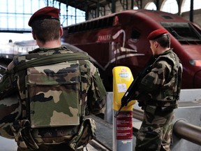 French soldiers patrol at Gare du Nord train station in Paris, France, Saturday, Aug. 22, 2015. A gunman prepared to open fire with an automatic weapon on a high-speed train traveling from Amsterdam to Paris on Friday, wounding several people before being subdued by passengers, officials said. (AP Photo/Binta)