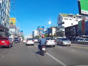 Motorists captured an unknown fireball lighting the skies of Bangkok on Tuesday morning. (YouTube/Screengrab)
