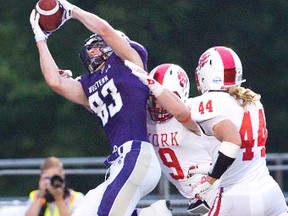 Western Mustangs Harry McMaster makes a touchdown catch while being covered by York Lions Rees Patterson (9) and Connor Pritty during the first quarter of their OUA game at TD Stadium in London, Ont. on Monday September 7, 2015. (DEREK RUTTAN, The London Free Press)