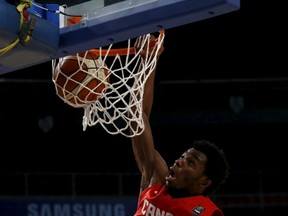 Canada’s Andrew Wiggins dunks over a Uruguay player last night in Mexico. Wiggins had 18 points in the victory. (Reuters)