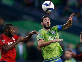 Seattle Sounders FC midfielder Brad Evans (right) wins a header over Toronto FC defender Ashtone Morgan in the first half of their MLS game Saturday at CenturyLink Field. Seattle won 2-1, with Clint Dempsey scoring the decisive goal in the 77th minute. (JENNIFER BUCHANAN/USA Today Sports)