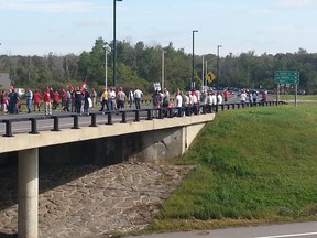 Whistles blowing, roughly 40 cabbies block traffic on the Airport Parkway Bridge to the airport on Sept. 8, 2015. (SAM COOLEY Ottawa Sun / Postmedia Network)