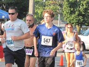 Approximately 100 runners, including five-year-old Akira Labadie (far right), took part in the fourth annual Maple City Mile that was held on Sept.6.