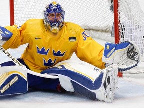 Goaltender Henrik Lundqvist of Sweden watches an approaching puck during the gold medal hockey game against Canada at the 2014 Winter Olympics, Sunday, Feb. 23, 2014, in Sochi, Russia. (THE CANADIAN PRESS/AP/Petr David Josek)