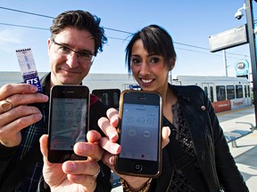 Edmonton Sun reporters David Lazzarino, left, and Claire Theobald, right, hold up their elapsed times after taking the bus and the LRT from Churchill Station to the NAIT station in Edmonton, Alta. on Tuesday, Sept. 8, 2015.Codie McLachlan/Edmonton Sun