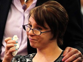 Michelle Knight, one of the three kidnapped women, pauses to wipe away tears as she reads her statements during the sentencing of her accused kidnapper Ariel Castro at a court hearing in Cleveland, Ohio August 1, 2013. Three women imprisoned for a decade in a Cleveland home spoke of their abuse in person, via video or through representatives on Thursday at a court hearing where their abductor is expected to be formally sentenced to life in prison. REUTERS/Aaron Josefczyk