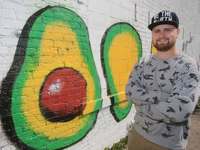Art student Jon Philpott stands with his avocado mural in Winnipeg, Man. Tuesday Sept. 8, 2015.