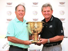 Jay Haas (left), the captain of the United States team, and Nick Price, the International captain pose with the trophy during the Presidents Cup at the Trump National Resort on March 4, 2015 in Doral, Fla. (David Cannon/Getty Images/AFP)