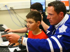 Maple Leafs captain Dion Phaneuf helps out Satchel Gore, 12, during the NHL and NHLPA Future Goals Program that helps students build their science, technology, engineering and math (STEM) skills at Glen Ames Sr. Public School in Toronto on Tuesday, Sept. 8, 2015. (Dave Abel/Toronto Sun)