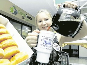 Luke Hendry/The Intelligencer
Amelia Huffman, of the Alzheimer Society of Hastings-Prince Edward, pours coffee outside the society's office in Belleville Tuesday. Staff are asking residents to support their annual Coffee Break and doughnut sale programs. The society aids more than 2,200 people.