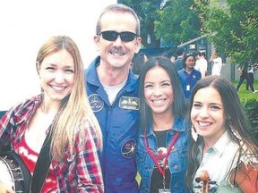 Astronaut Chris Hadfield joins Trent Severn?s Dayna Manning, left, Emm Gryner and Laura Bates for a photo during Canada Day celebrations in Ottawa earlier this year. Trent Severn and Hadfiled play the Grand Theatre in London on Oct. 7.