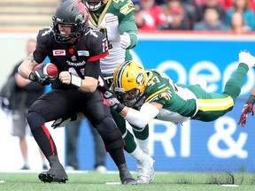 Eskimos LB JC Sherritt, shown here helping to tackle Stampeders quarterback Bo Levi Mitchell in Monday's game in Calgary, says the extra day before the Labour Day rematch was a welcome change. (Darren Makowichuk, Postmedia Network)