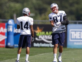 New England Patriots wide receiver Chris Harper (left) and tight end Rob Gronkowski talk while warming up on the field during their team’s workout on Tuesday. The Patriots face the Pittsburgh Steelers in the NFL opener on Thursday. (STEVEN SENNE/AP)