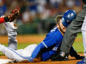 Toronto Blue Jays third baseman Josh Donaldson dives into third base against the Boston Red Sox during the tenth inning at Fenway Park. (Mark L. Baer/USA TODAY Sports)
