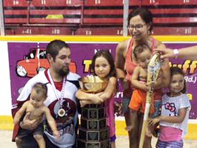 Isaiah Kicknosway of Walpole Island gathers his family around the Presidents Cup after winning the Canadian senior 'B' lacrosse championship with the Six Nations Rivermen on Saturday in St. Catharines. (Contributed Photo)