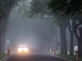 A car drives on 70 Avenue and 105 Street.  Fog covered most of Edmonton the morning of Sept. 9, 2015. Perry Mah/Edmonton Sun/Postmedia