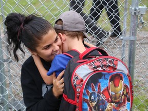 Owynn Vaillancourt, 5, hugs his mom, Melyna, at the first day of school for 2015-2016 at Ecole St-Joseph in Sudbury, Ont. on Tuesday September 8, 2015. John Lappa/Sudbury Star/Postmedia Network