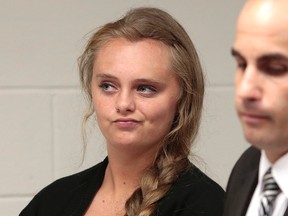 In this Aug. 24, 2015 file photo, Michelle Carter listens to defense attorney Joseph P. Cataldo argue for an involuntary manslaughter charge against her to be dismissed at Juvenile Court in New Bedford, Mass. Carter, 18, of Plainville, Mass., is charged with involuntary manslaughter for allegedly pressuring Conrad Roy III, 18, of Fairhaven, Mass., to commit suicide on July 13, 2014. (Peter Pereira/The New Bedford Standard Times via AP, Pool, File)