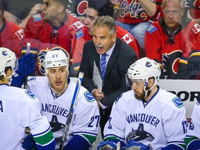 Vancouver Canucks coach Willie Desjardins talks to his players during a game against the Calgary Flames in the Stanley Cup playoffs at Scotiabank Saddledome. (Sergei Belski/USA TODAY Sports)