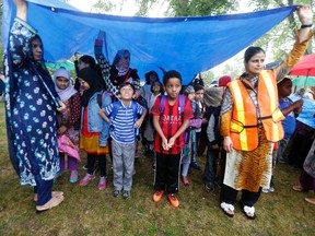 Students from Thorncliffe Park Public School whose parents oppose the new sex-ed curriculum get home-schooled in the rain. (MICHAEL PEAKE/Toronto Sun/Postmedia Network)