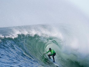 Shawn Dollar of the U.S. rides in a barrel during the final round of the Mavericks Invitational surfing competition in Half Moon Bay, Calif., January 20, 2013. (REUTERS/Stephen Lam)