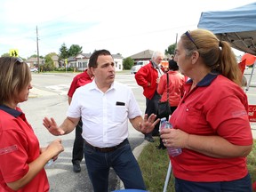Nickel Belt Liberal candidate Marc Serre, middle, talks to Valerie Lauria, left, and Sherry Desjardins at the opening of his campaign headquarters in Hanmer, Ont. on Wednesday September 9, 2015. John Lappa/Sudbury Star/Postmedia Network
