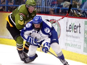 Sudbury Wolves rookie hopeful Ben Garagan and North Bay Battalion defenceman Jake Ramalho battle for the puck during OHL exibition action from the Sudbury Community Arena on Sunday September 6/2015. Garagan is one of a handful of youngsters who is making making a case for a roster spot.