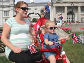 Rachael MacDermid and her daughter Maeve, 2, brought their Union Jack flags to a ceremony in Confederation Park in Kingston on Wednesday to mark Queen Elizabeth II as the longest-serving British monarch in history. (Michael Lea/The Whig-Standard)