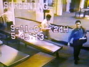 A still image taken from a surveillance camera shows two men identified by authorities as suspected hijackers Mohammed Atta (R) and Abdulaziz Alomari (C) passing through airport security at Portland International Jetport in Maine on September 11, 2001.