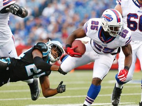 Buffalo Bills running back LeSean McCoy is tripped up by Carolina Panthers cornerback Josh Norman during an NFL pre-season game on Aug. 14, 2015, in Orchard Park, N.Y. (AP Photo/Heather Ainsworth)