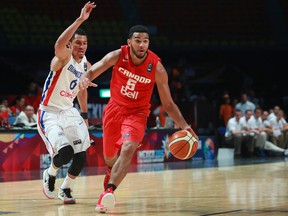 Canada's Cory Joseph (right) dribbles past Dominican Republic's Rigoberto Mendoza during their FIBA Americas Championship game in Mexico City on Wednesday, Sept. 9, 2015. (Christian Palma/AP Photo)