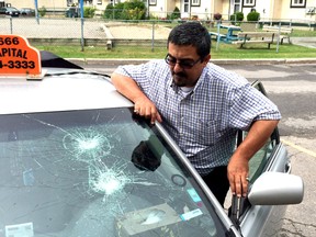 Taxi driver Bilal Sabra says his cab was vandalized overnight outside his home. He's concerned the ongoing labour dispute in Ottawa's taxi industry is escalating into tactics of harassment and intimidation. Sabra is seen Wednesday, Sept. 10, 2015 inspecting the damage done to his car overnight.

Corey Larocque, Ottawa Sun.