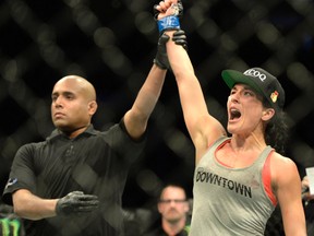 Valerie Letourneau has her hand raised after defeating Jessica Rakoczy during their women's strawweight bout during UFC 186 in Montreal on April 25, 2015. (Eric Bolte/USA TODAY Sports)