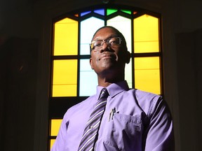 Rev. Dr. Anthony Bailey poses for a photo at the Parkdale United Church in Ottawa Ontario Wednesday Sept 9, 2015. Rev. Bailey is frustrated that the church is running into red tape while trying to sponsor a Syrian family.  Tony Caldwell/Ottawa Sun/Postmedia Network