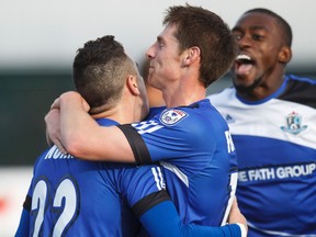 Edmonton defender Michael Nonni (22) celebrates his goal with forward Daryl Fordyce (16) and defender Kareem Moses (12) against Atlanta during the first half of a NASL soccer game between FC Edmonton and the Atlanta Silverbacks at Clarke Stadium in Edmonton, Alta., on Sunday, Nov. 2, 2014. Edmonton won 2-1. Ian Kucerak/Edmonton Sun