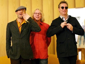 R.E.M. band members Peter Buck (R), Michael Stipe (L) and Mike Mills (C) pose for photos in Madrid in this September 9, 2004 file photo. The band members are upset presidential candidate Donald Trump has used their song It's The End Of The World as a campaign tune. REUTERS/Susana Vera/Files