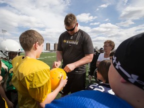 Matt O'Donnell, shown here signing autographs during a junior football camp in 2014, could start against the Stampeders on Saturday. (Ian Kucerak, Edmonton Sun)