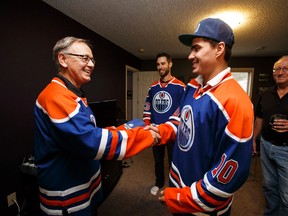 Longtime fan Bob Kindrachuk shakes hands with Nail Yakupov as Cam Talbot looks on when the duo dropped of Kindrachuk’s season tickets on Wednesday. Yakupov says he’s looking forward to playing with the Oilers’ current group of centres, adding that as a fourth-year player, getting ready for the season is easier. (Ian Kucerak, Edmonton Sun)