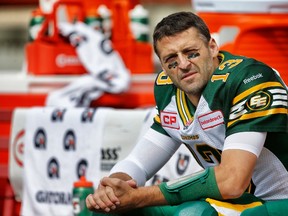 Mike Reilly sits on the bench during Monday's game against the Stampeders in Calgary. (Al Charest, Postmedia Network)