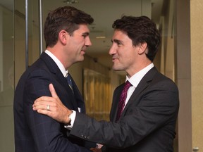 Liberal leader Justin Trudeau, right, is greeted by Edmonton Mayor Don Iveson at city hall in Edmonton on Wednesday. THE CANADIAN PRESS/Jonathan Hayward