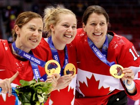 Left to right, Jayna Hefford of Kingston, Ont., Haley Irwin of Thunder Bay, Ont., and Gillian Apps of Unionville, Ont., celebrate after beating Team USA 3-2 in overtime to win the women's ice hockey gold medal at the Bolshoy Ice Dome at the Sochi 2014 Winter Olympics in Sochi, Russia, on Feb. 20, 2014. (Al Charest/Calgary Sun/Postmedia Network)