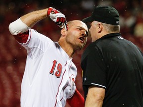Cincinnati Reds' Joey Votto (19) argues with umpire Bill Welke after being thrown out of the game for arguing balls and strikes during the eighth inning of a baseball game against the Pittsburgh Pirates, Wednesday, Sept. 9, 2015, in Cincinnati. (AP Photo/John Minchillo)